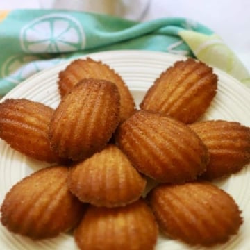 A white plate with madeleine cakes.