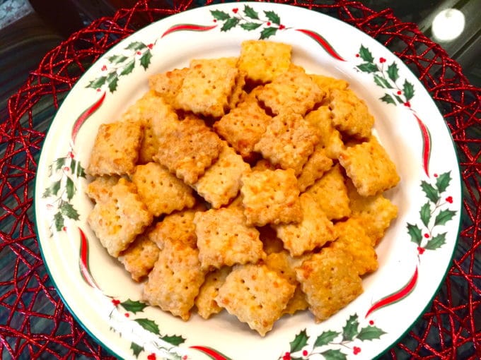 A Christmas plate with a pile of homemade baked cheez its.