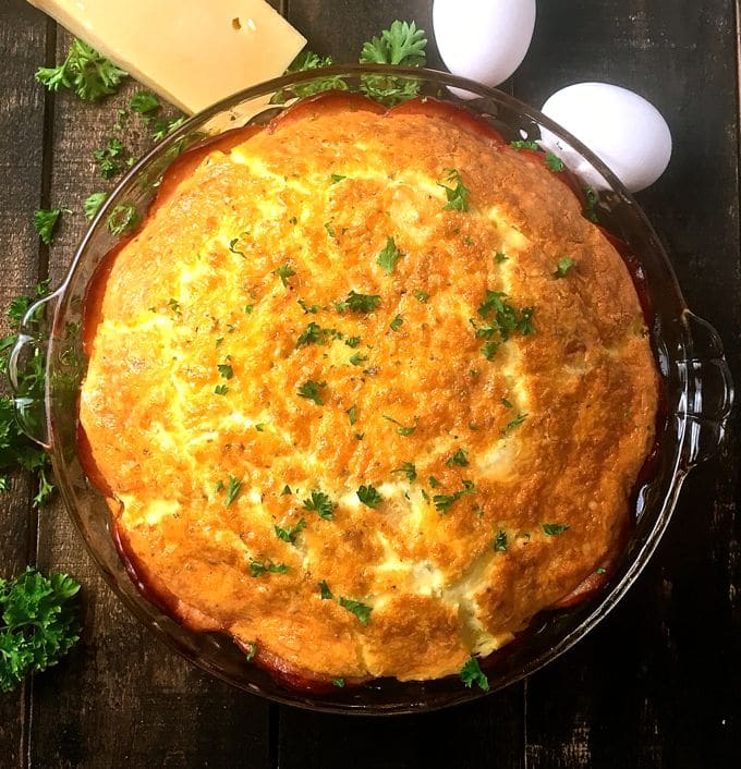 Canadian Bacon and Brie Quiche in a glass pie dish.