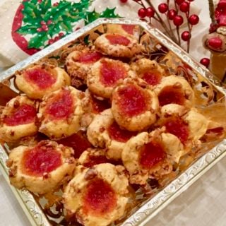 A silver serving dish with Cornmeal Cookies with Tomato Jam