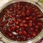Glazed turkey meatballs with grape jelly and chili sauce in a chafing dish.