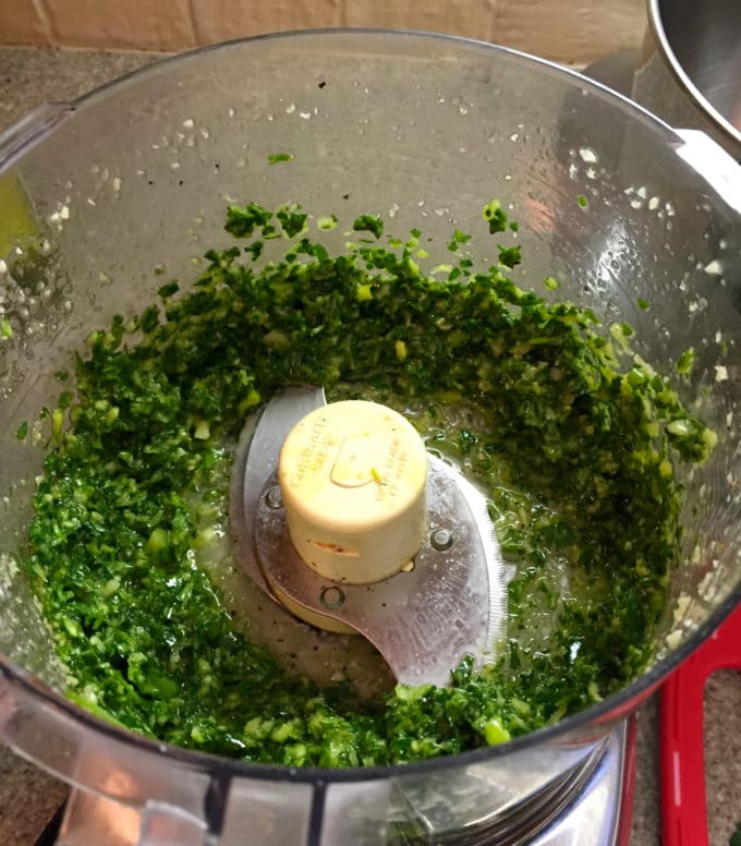 Parsley, scallions and olive oil in a food processor for Spicy Shrimp and Green Sauce