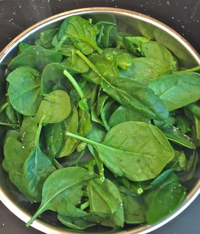 Cooking baby spinach for Sautéed Spinach with Lemon and Garlic