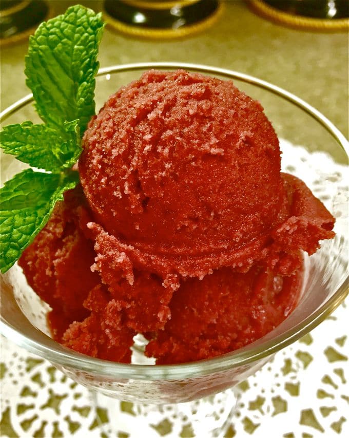 Cherry Pomegranate Sherbet in a glass ice cream cup.