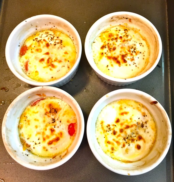 Four Baked Egg Cups on a baking sheet.