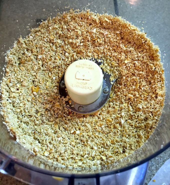 Grinding oatmeal into flour using a food processor.