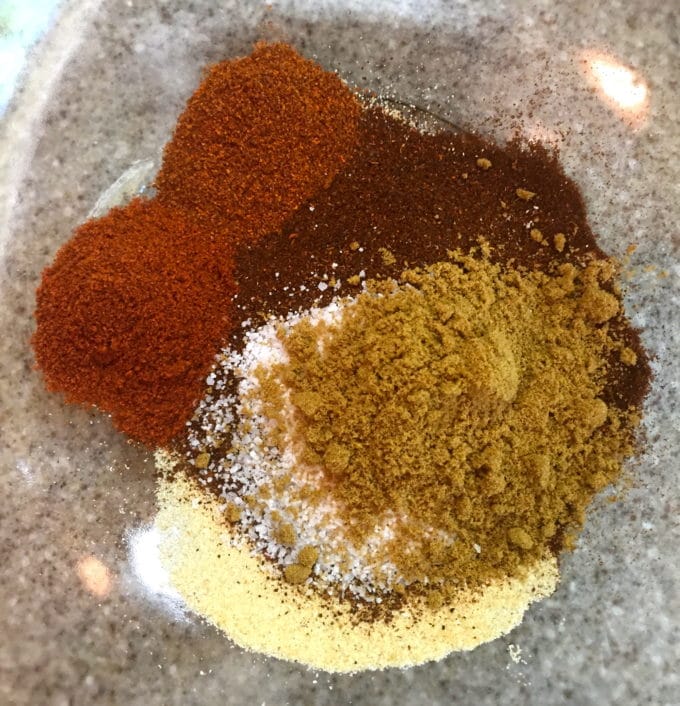 Chili- rub ingredients in a large glass bowl.