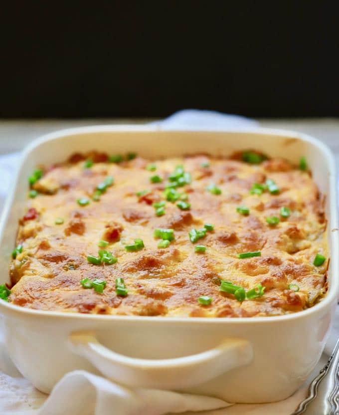  King Ranch Chicken Casserole in a white baking dish garnished with chopped chives.