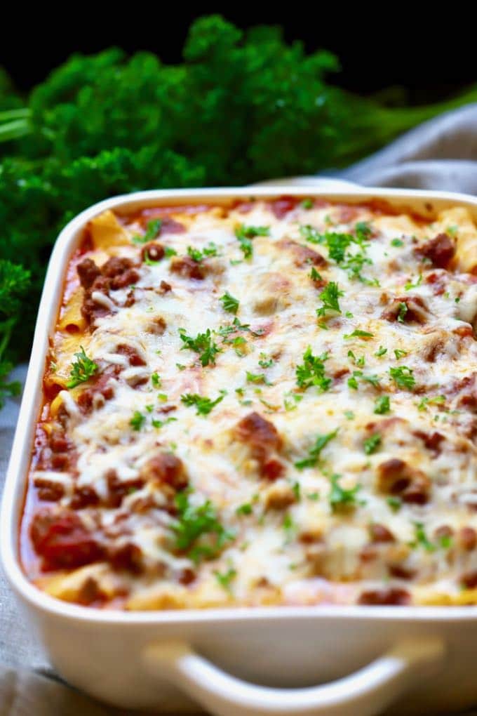 Easy Make Ahead Baked Ziti right out of the oven in a white baking dish and ready to serve