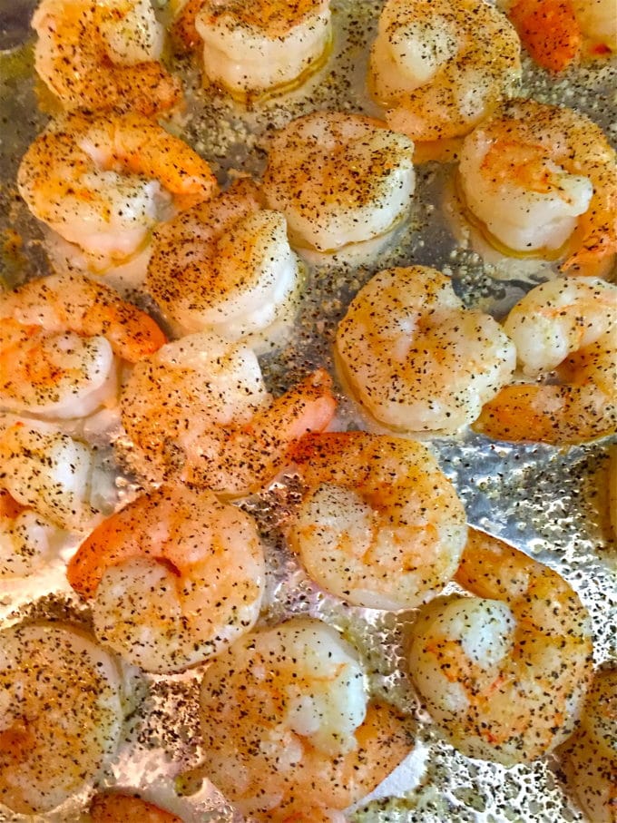 Roasted shrimp on a baking sheet right out of the oven. 