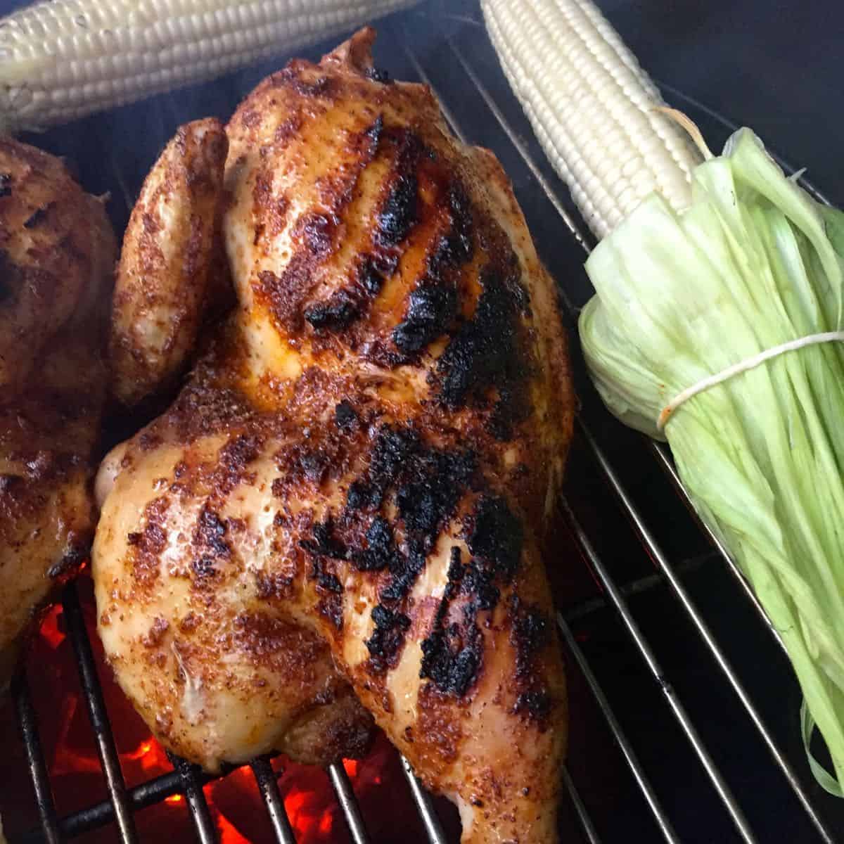 Chicken on the grill with corn.