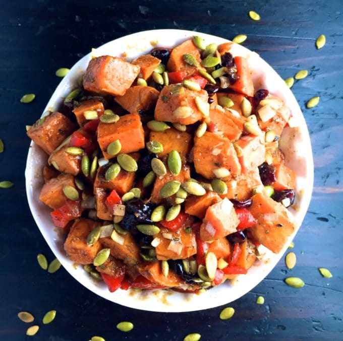  Sweet Potato Salad in a white bowl topped with sunflower seeds. 