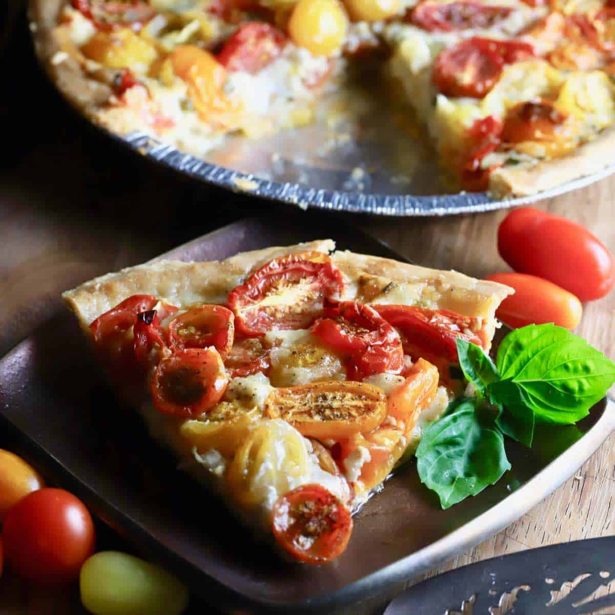 Cherry Tomato Pie in a pie dish on a white napkin ready to eat!