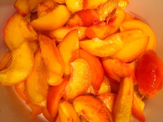 Sliced peaches in a large bowl.