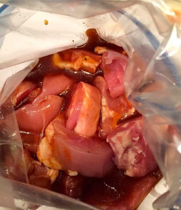 Marinade mixture and chicken in a gallon size plastic bag.
