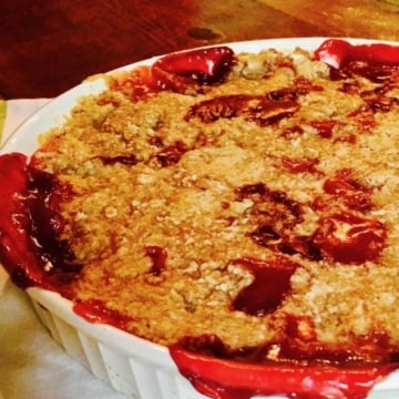 Peach and Blackberry Crumble in a white medium size baking dish.