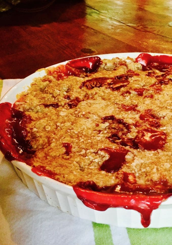 Peach and Blackberry Crumble in a white medium size baking dish.