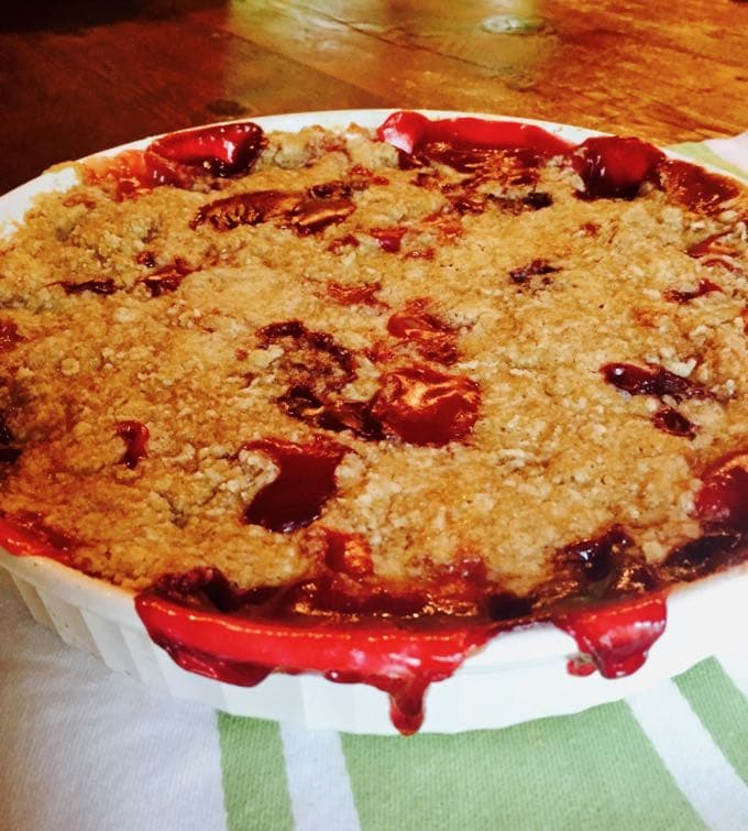Peach and Blackberry Crumble in a white medium size baking dish.