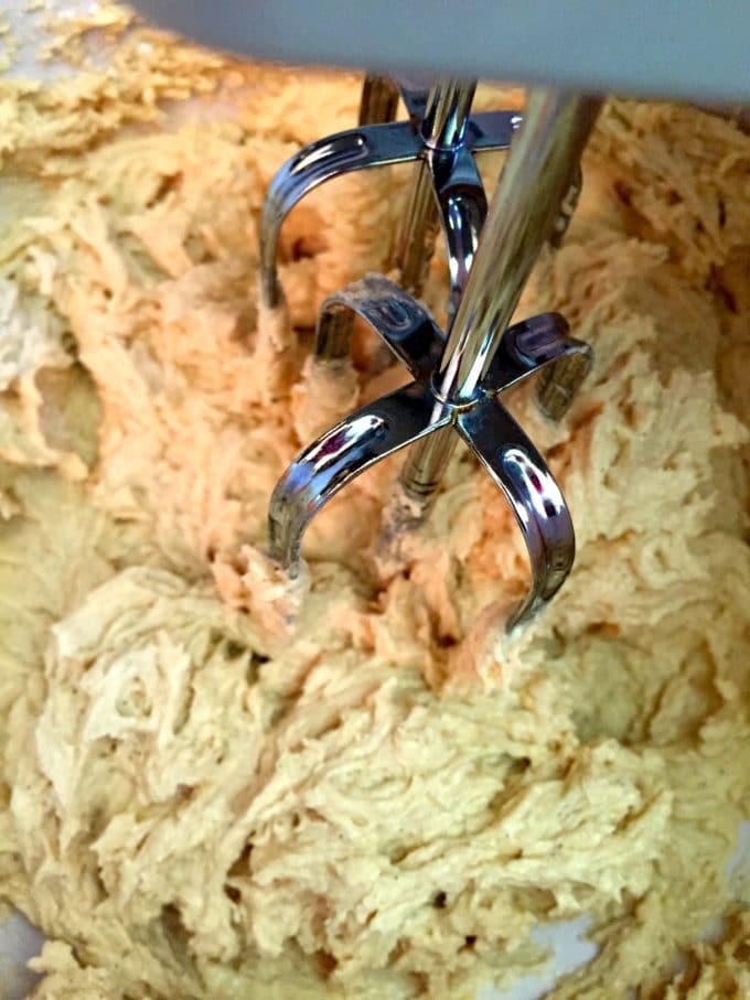 Using an electric mixer to make cookie dough. 