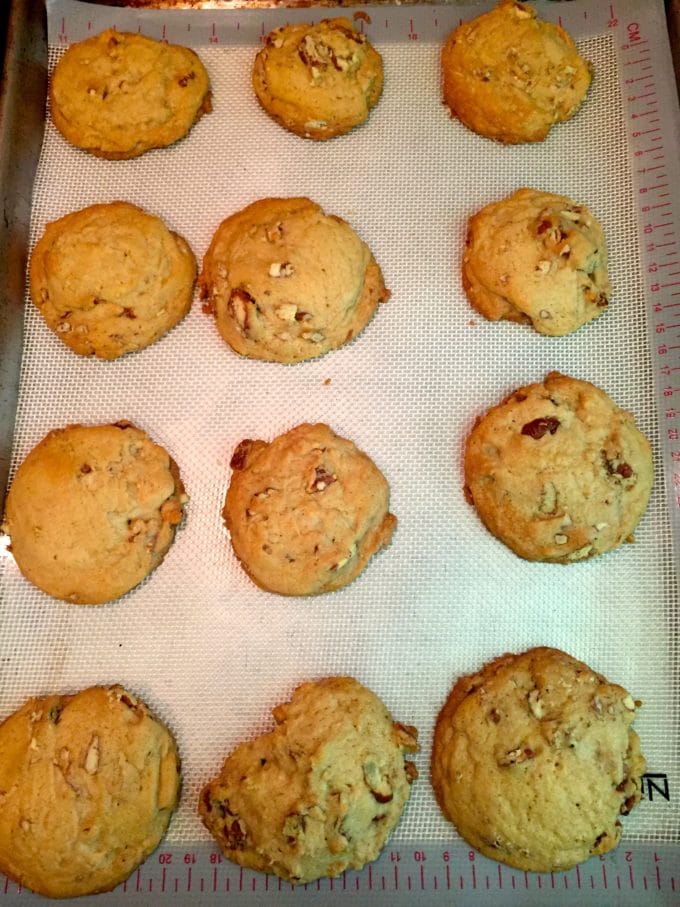 Cookies right out of the oven cooling on a baking sheet. 