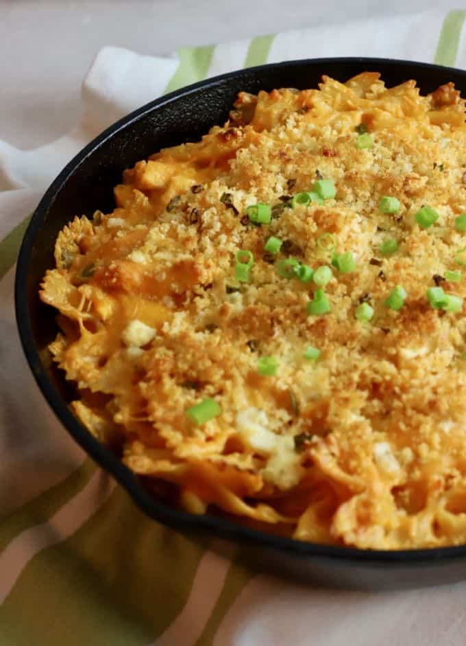 A cast-iron skillet full of buffalo chicken pasta ready to eat.