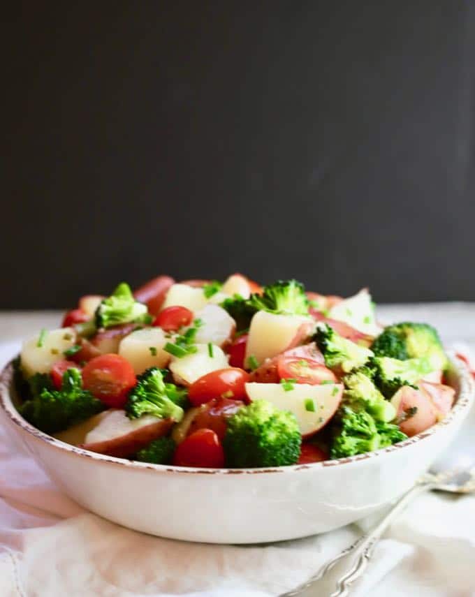 Potato Broccoli Salad with Vinaigrette in a serving bowl on a table