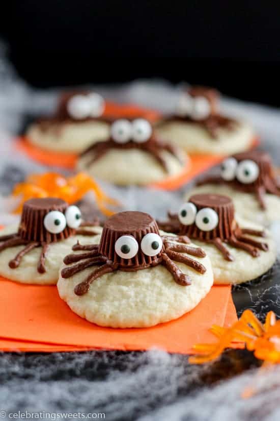 Halloween Spider Cookies on an orange plate made with cookies and reese's peanut butter cups. 