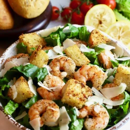 Shrimp Caesar Salad with Homemade croutons and homemade dressing in a bowl.