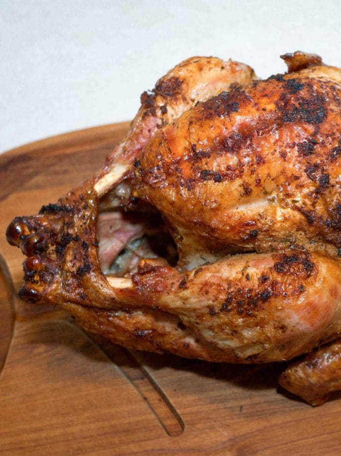 Cajun Fried Turkey on a cutting board ready to carve.