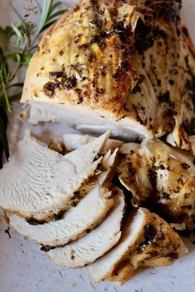 A sliced turkey breast on a platter.