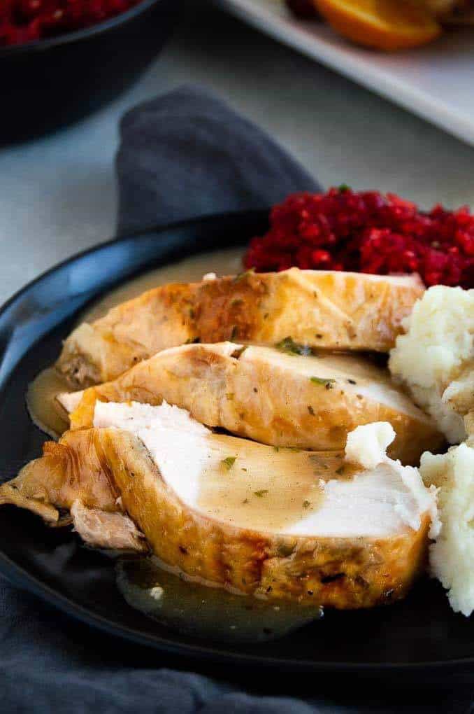 Sliced turkey breast with cranberry relish on the side. 