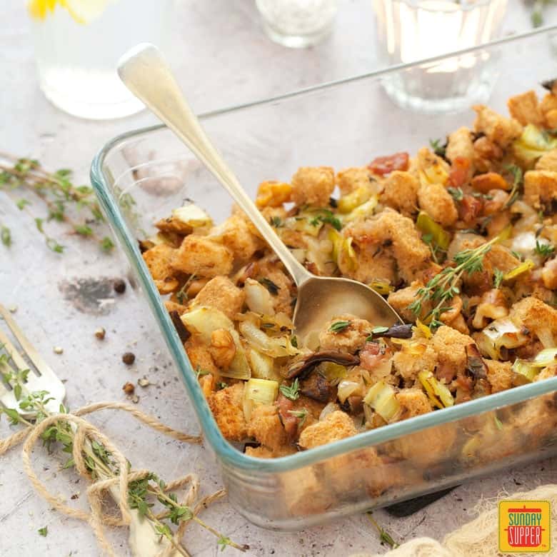 Gluten free stuffing in a clear glass baking dish. 