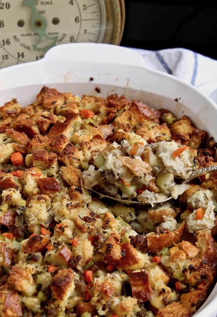 Old fashioned bread stuffing in a white baking dish. 