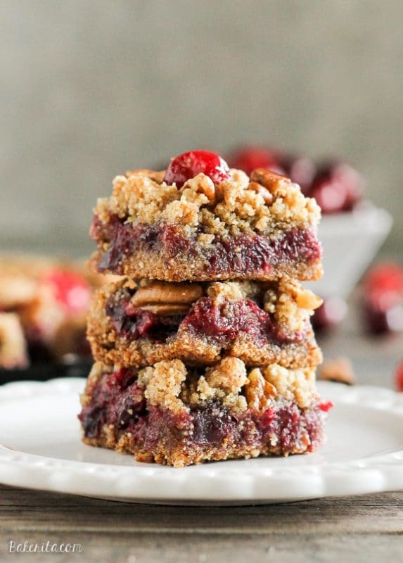 Paleo Cranberry Crumb Bars stacked on a plate. 