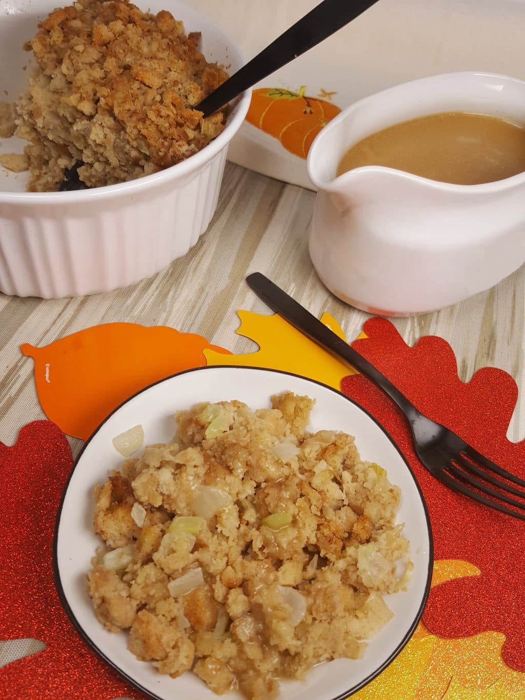 A plate of stuffing cooked in an Instant Pot along with a bowl of turkey gravy. 