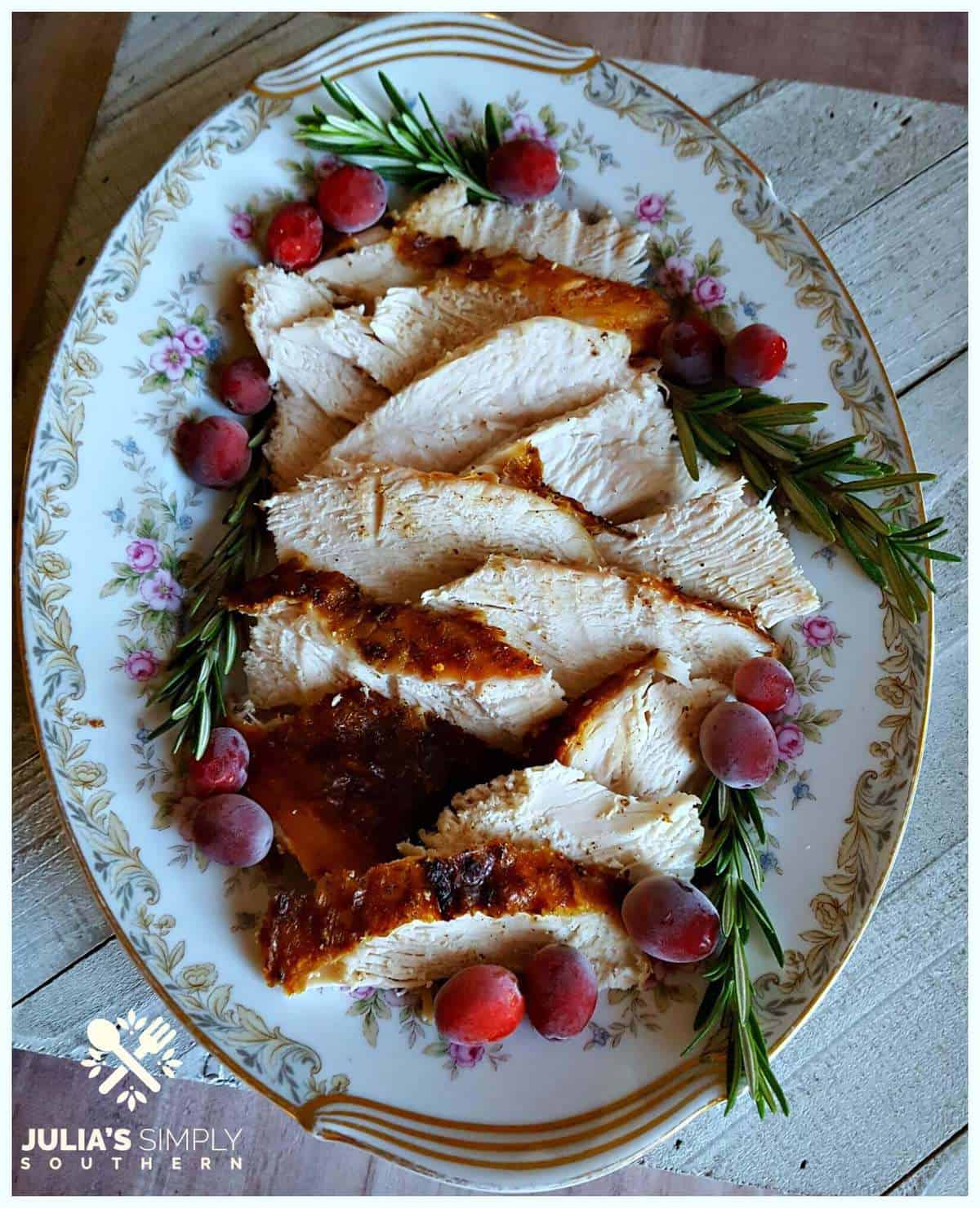 Sliced turkey breast on a plate with flowers.