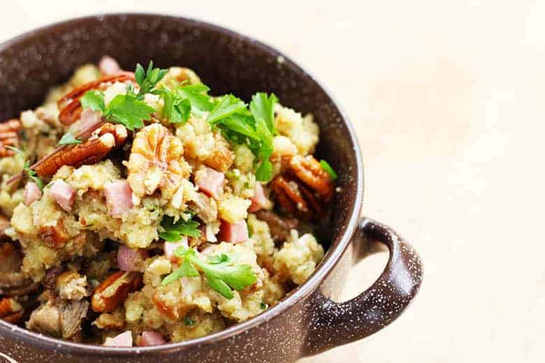 A metal bowl with Thanksgiving stuffing with smoked oysters. 