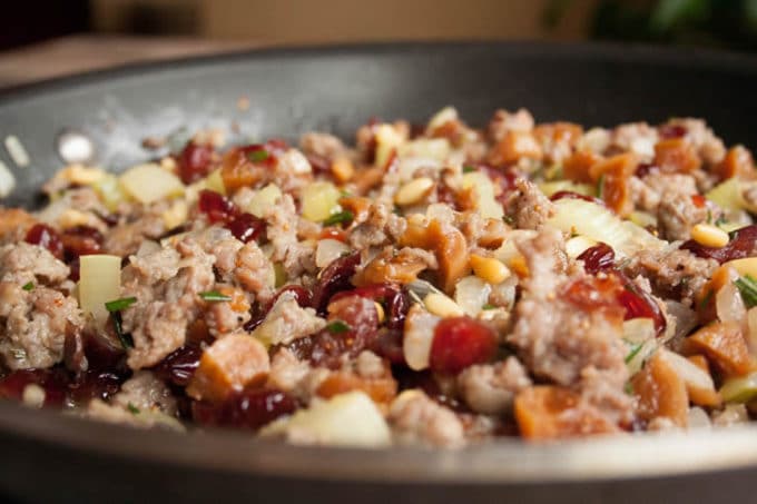 Sausage Fig and Cranberry Stuffing in a skillet cooking on the stove. 