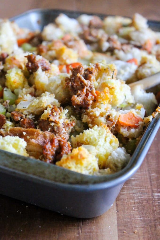 A bowl of cornbread stuffing with sausage. 