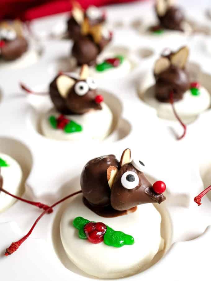 Adorable chocolate Christmas mice made with chocolate covered cherries and white chocolate covered Oreos. 