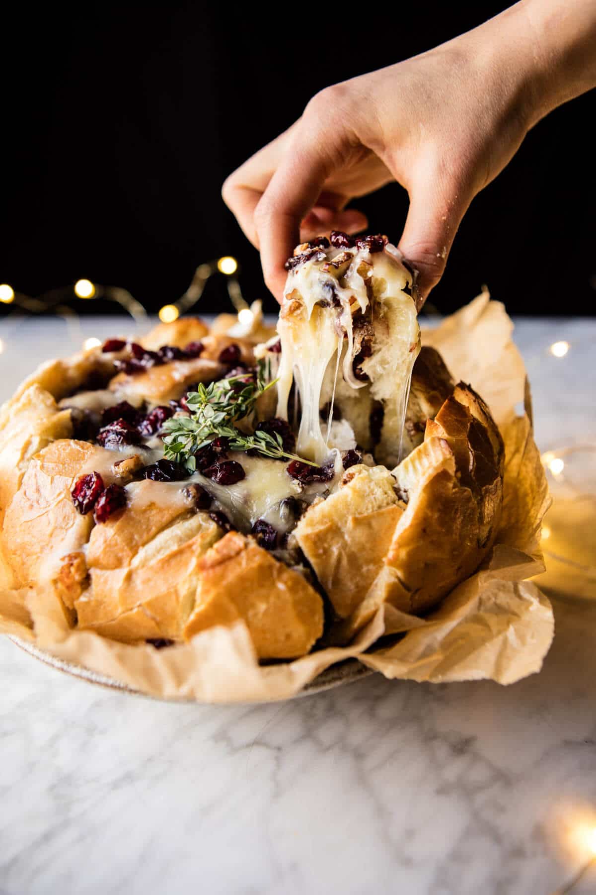 Cranberry brie pull apart bread with a hunk being pulled out. 