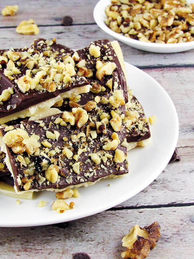 Pieces of English toffee on a white plate. 