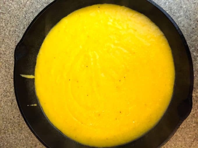 Cooking polenta in a cast iron skillet for Beef and Tomato Skillet with Polenta