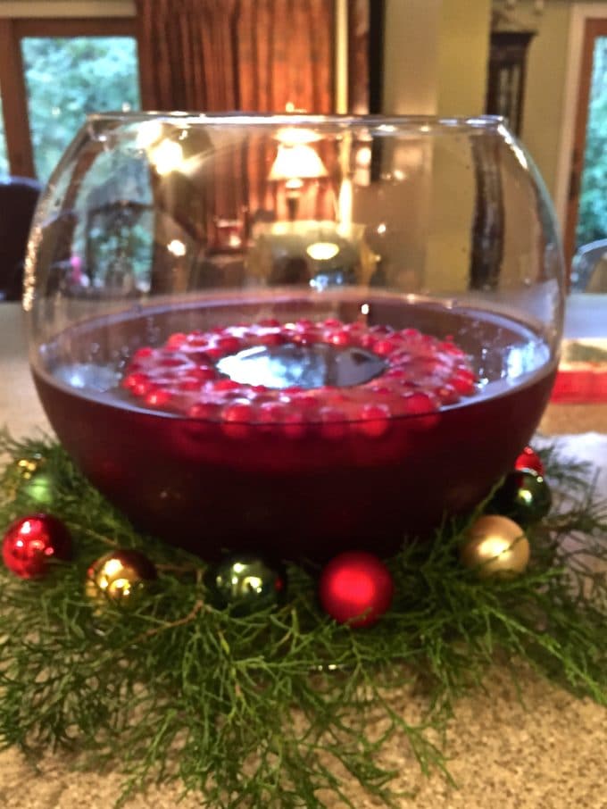 Santa Clause Christmas Punch in a large glass punch bowl with a frozen cranberry ring. 