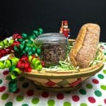 Olive Tapenade in a gift basket with a baguette and ribbons.