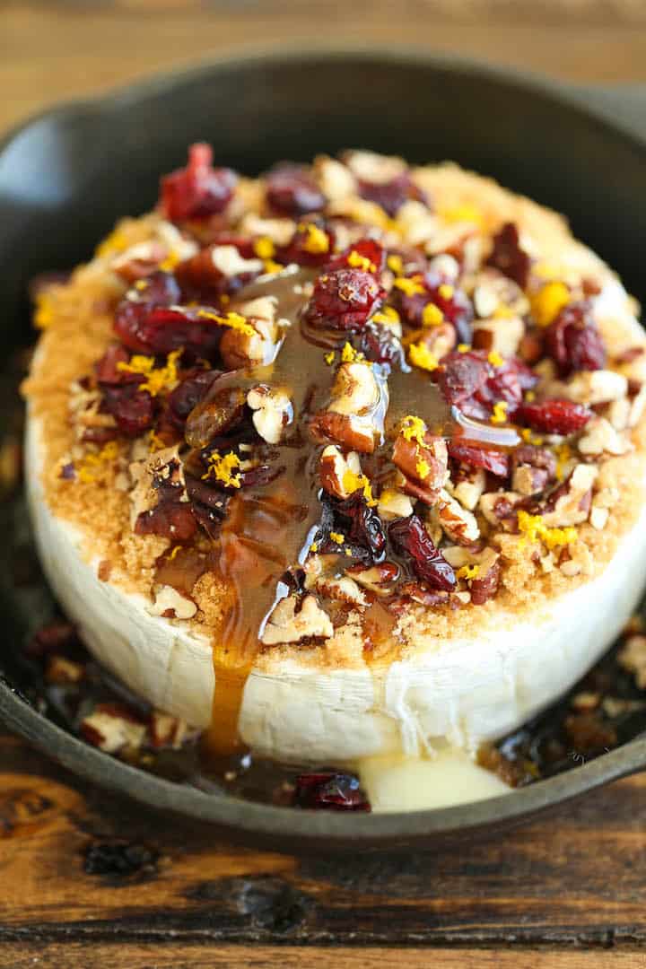 Cranberry pecan baked brie in a skillet. 