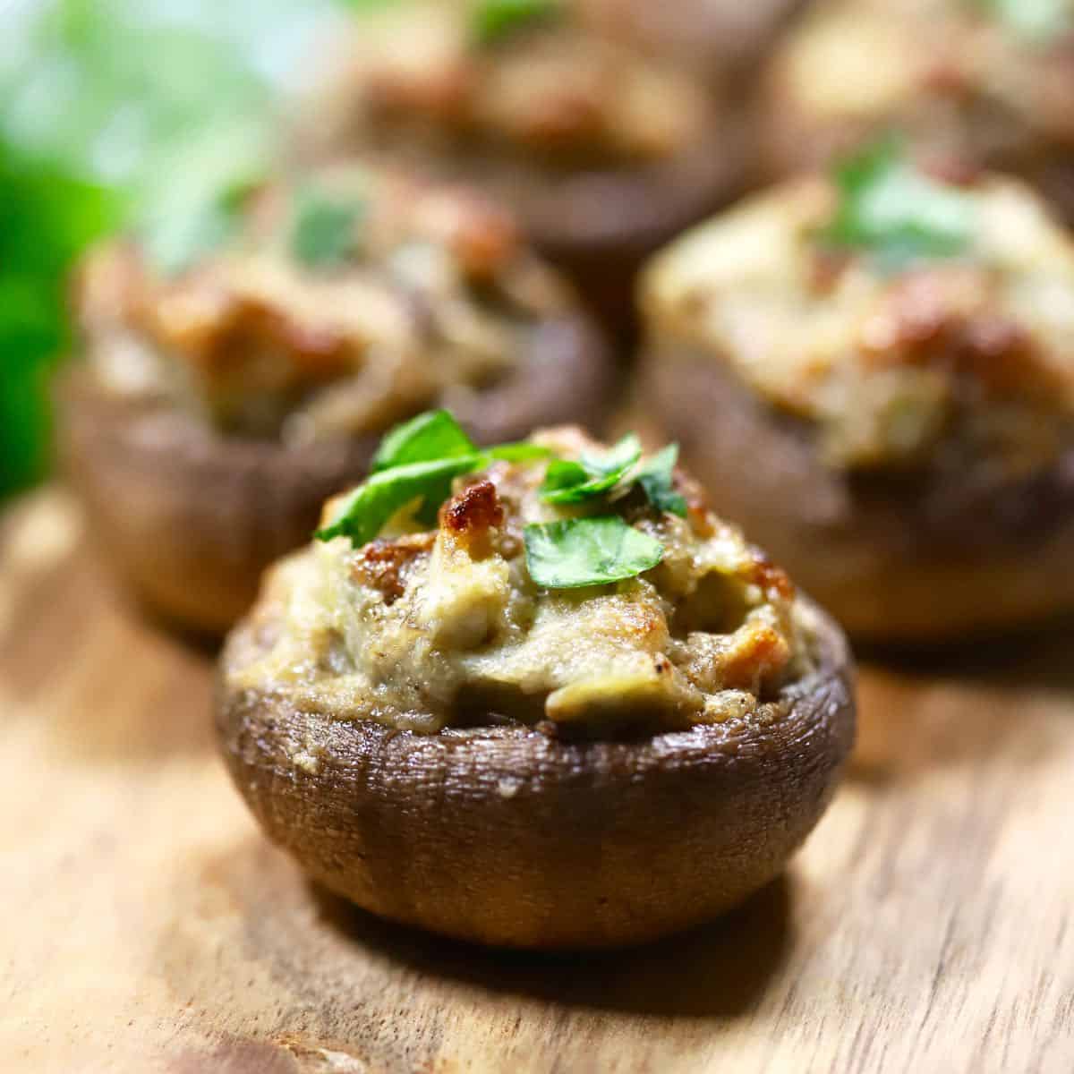 Easy Artichoke Stuffed Mushrooms on a baking sheet hot out of the oven.