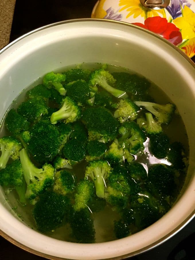 Cooking the broccoli in a large pot of water.