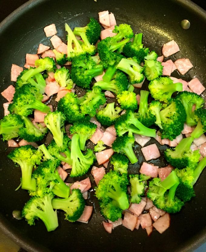 Broccoli and Canadian bacon in a large saute pan.