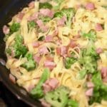 Fettuccine Alfredo with Broccoli and Canadian Bacon in a skillet.